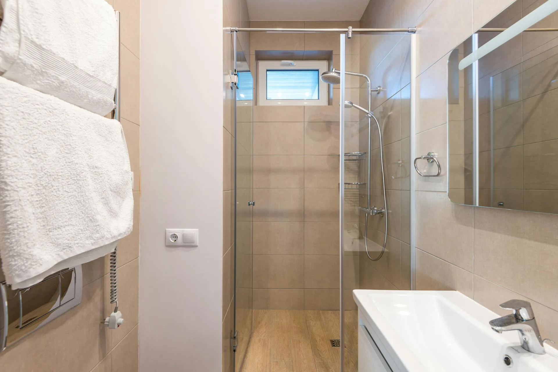 Contemporary bathroom with glass shower and beige tiles